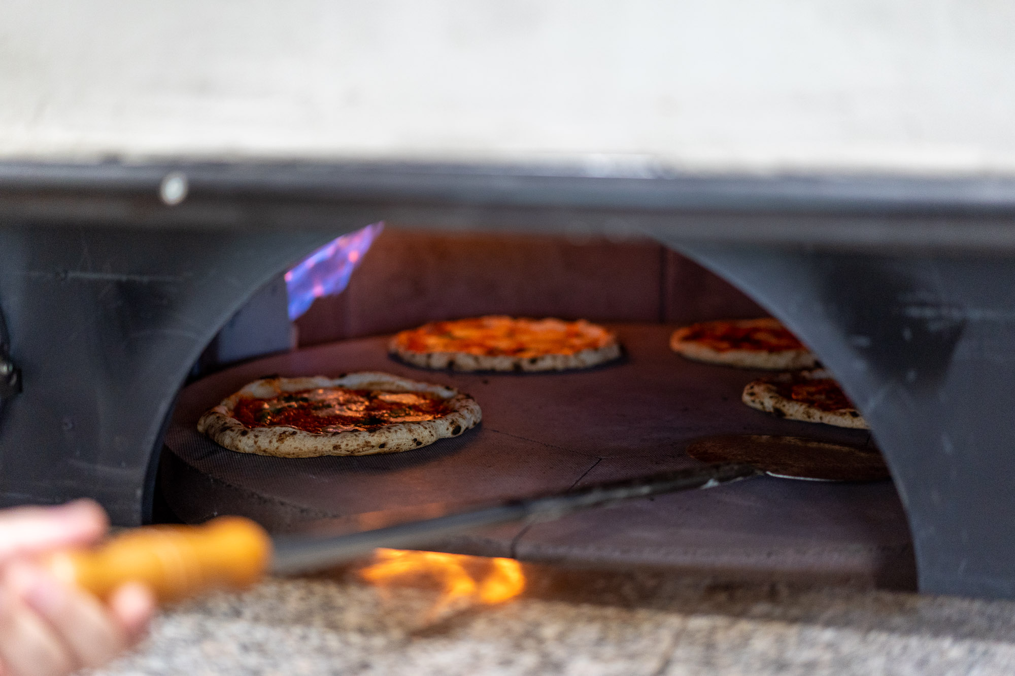 Pizza being prepared in the kitchen at T Minus Pizzeria Italian restaurant